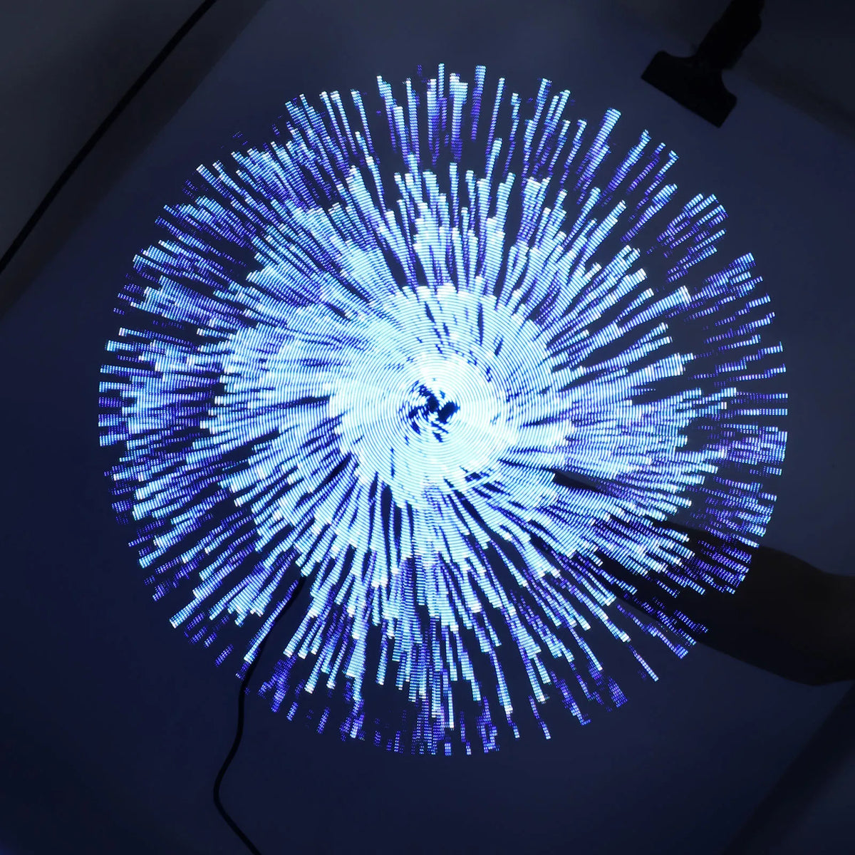 3D hologram fan displaying a circular blue and white LED light pattern against a dark background