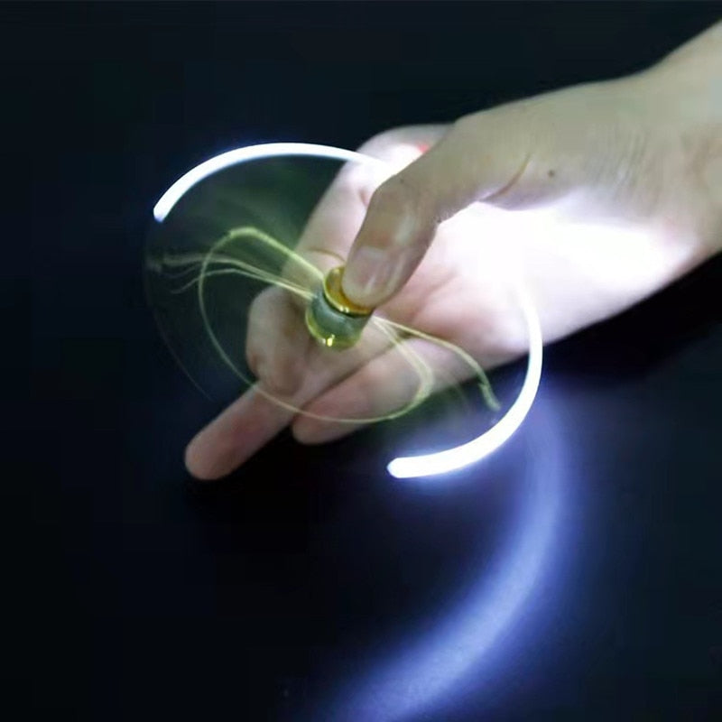 Hand spinning an LED pen, creating curved white light trails against a dark background
